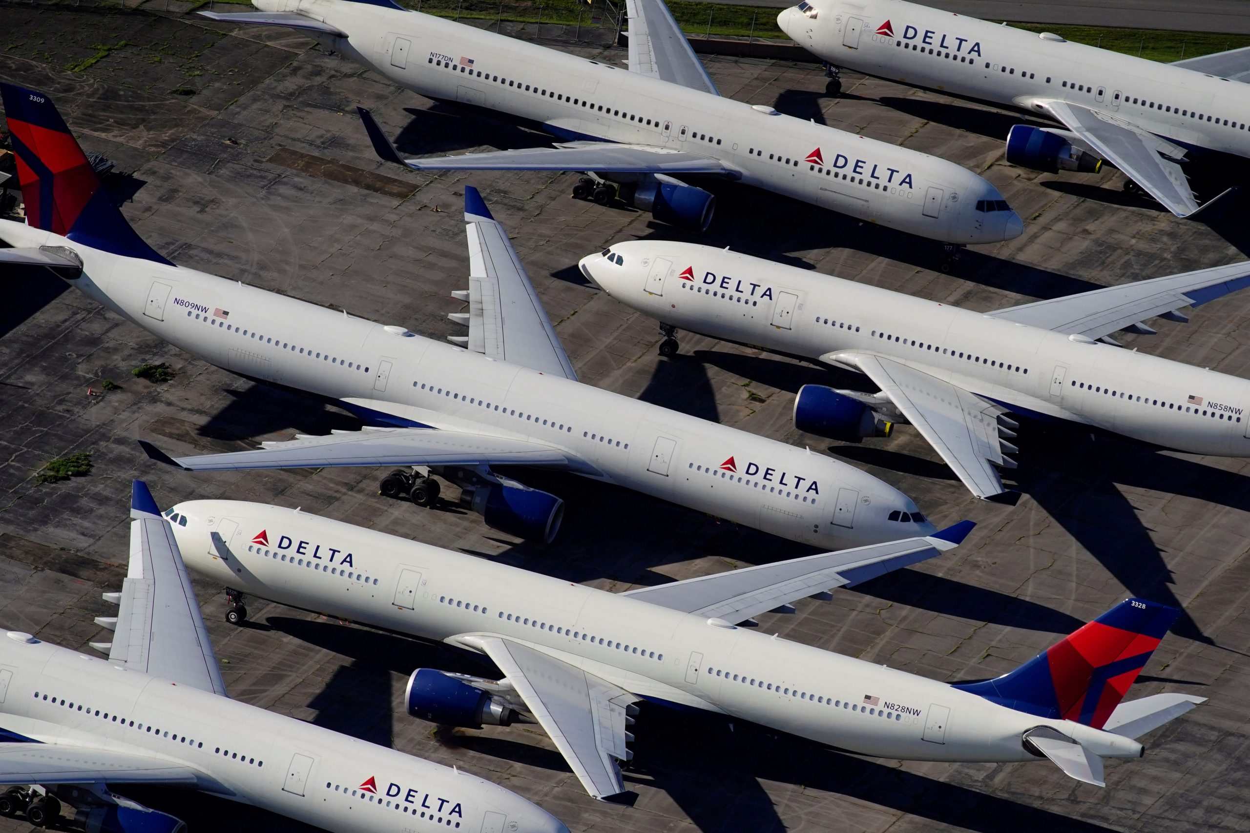 FILE PHOTO: Delta Air Lines passenger planes are seen parked due to flight reductions made to slow the spread of coronavirus disease (COVID-19), at Birmingham-Shuttlesworth International Airport in Birmingham, Alabama, U.S. March 25, 2020.  REUTERS/Elijah Nouvelage/File Photo