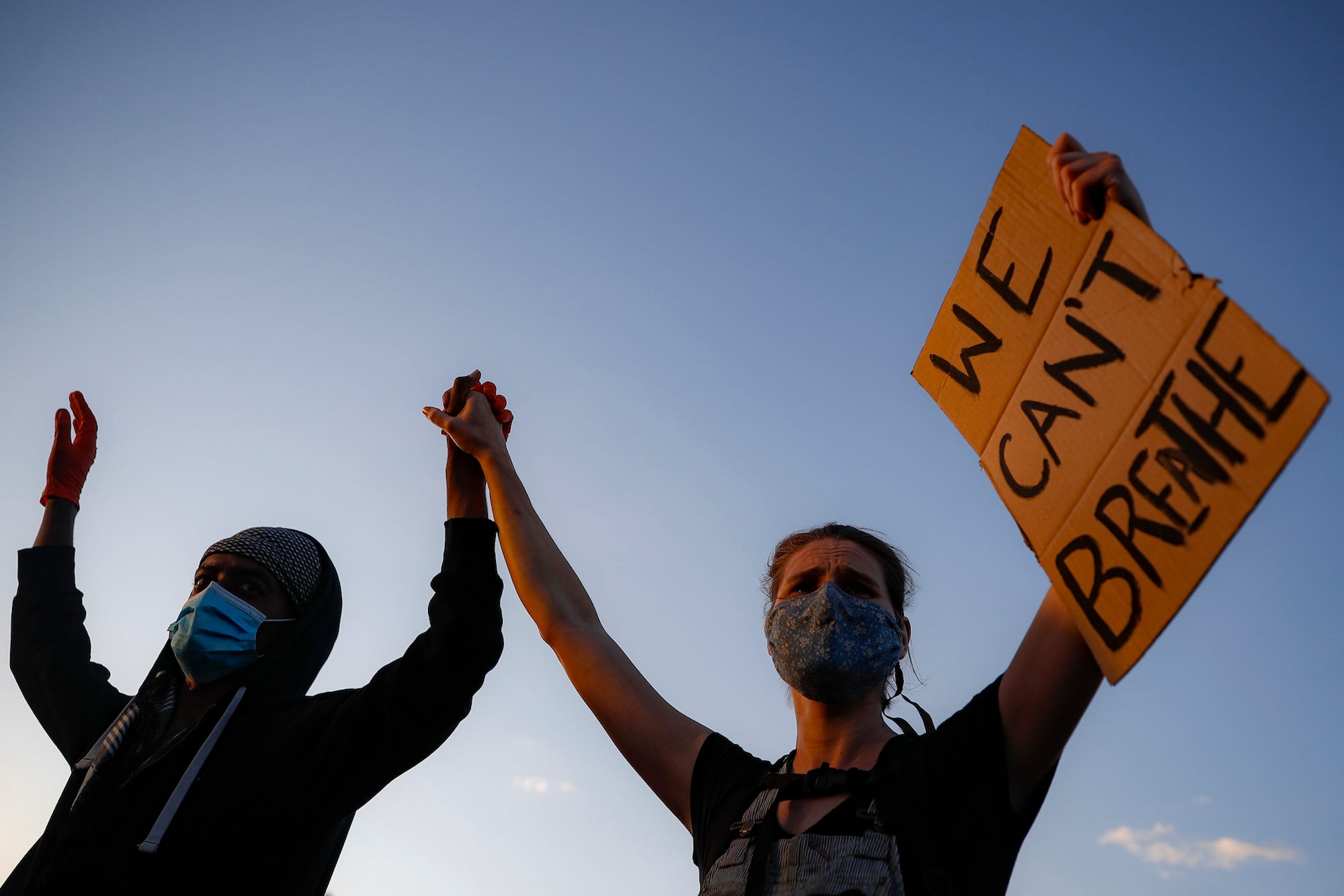 Protestors demonstrate in St. Paul, Minnesota while holding a "WE CAN'T BREATHE" sign, on May 28, 2020.