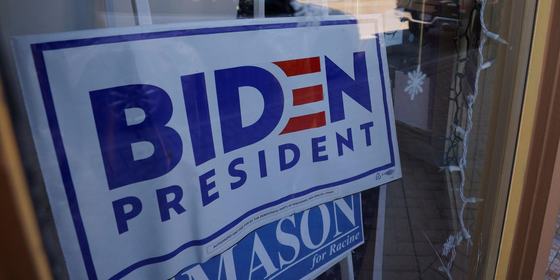 A sign supporting Democratic presidential nominee Joe Biden hangs in the window of the Racine County Democratic Party office, during the largely virtual Democratic National Convention (DNC), in Racine, Wisconsin, U.S., August 19, 2020.