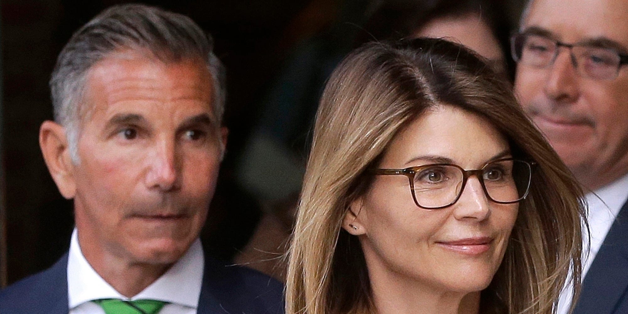 FILE - In this April 3, 2019, file photo, actress Lori Loughlin, front, and her husband, clothing designer Mossimo Giannulli, left, depart federal court in Boston after a hearing in a nationwide college admissions bribery scandal. A federal judge on Friday, May 8, 2020, refused to dismiss charges against the couple and other prominent parents accused of cheating in the college admissions process, siding with prosecutors who denied that investigators had fabricated evidence. (AP Photo/Steven Senne, File)