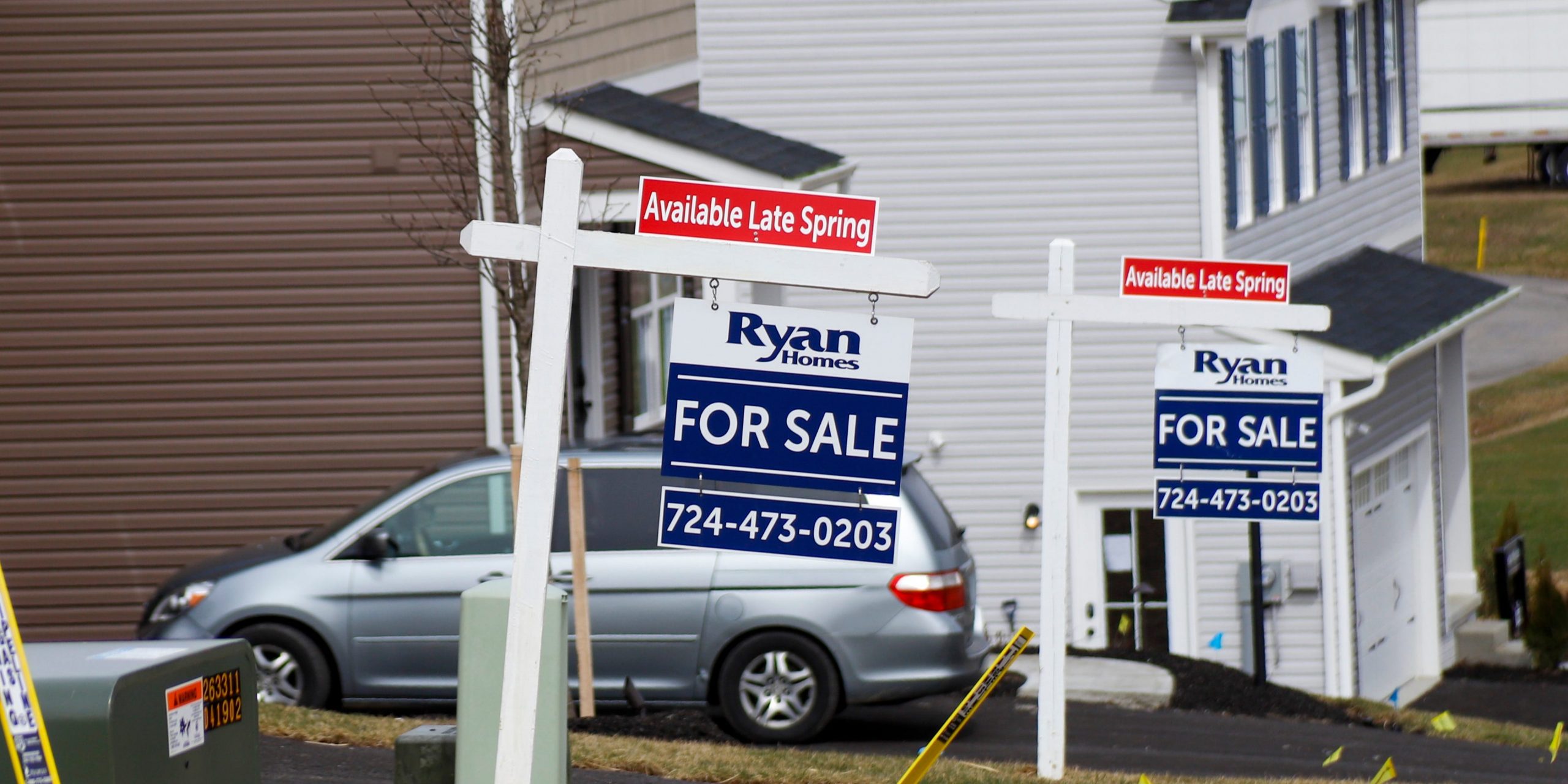 Model homes and for sale signs line the streets as construction continues at a housing plan in Zelienople, Pa., Wednesday, March 18, 2020.  U.S. new home sales fell 4.4% in February with bigger declines expected in coming months as the coronavirus puts a major crimp on home sales. (AP Photo/Keith Srakocic)