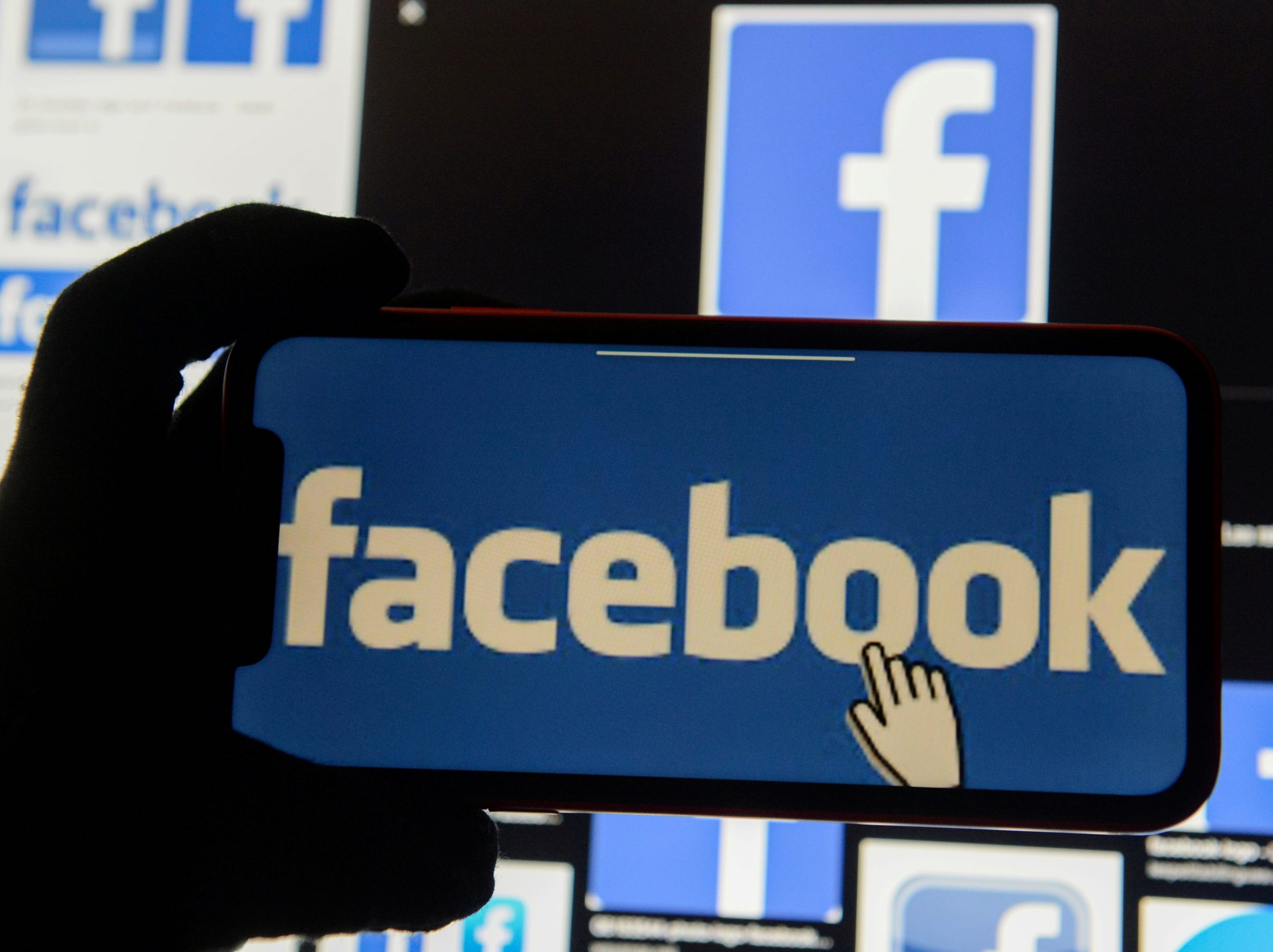 FILE PHOTO: The Facebook logo is displayed on a mobile phone in this picture illustration taken December 2, 2019. REUTERS/Johanna Geron/Illustration/File Photo