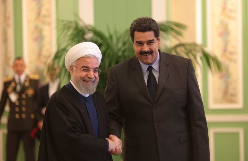 Venezuela's President Nicolas Maduro (R) is welcomed by Iran's President Hassan Rouhani in Tehran January 10, 2015. REUTERS/Miraflores Palace/Handout via Reuters