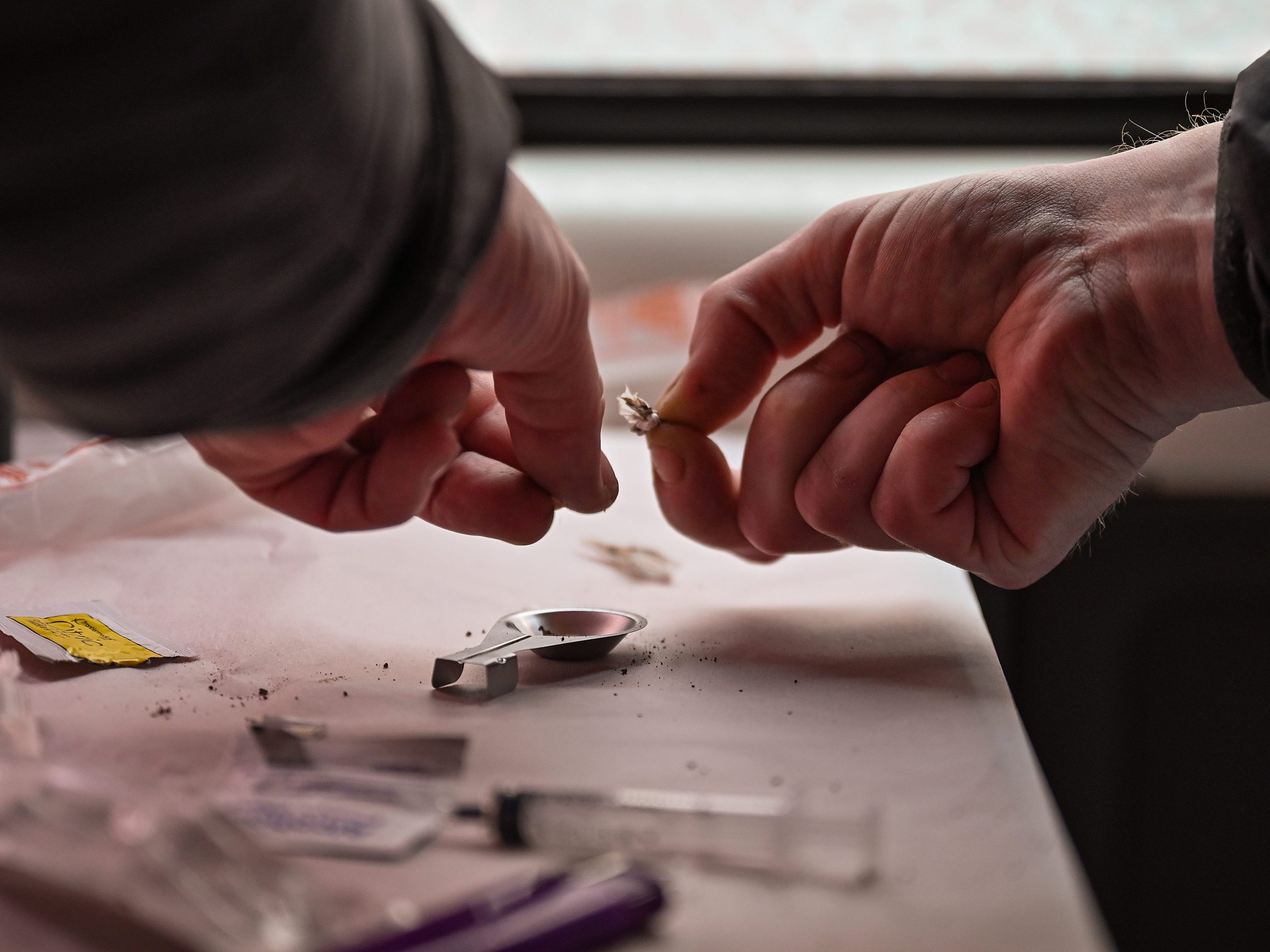 A drug user prepares heroin before injecting inside of a Safe Consumption van on September 25, 2020 in Glasgow, Scotland.
