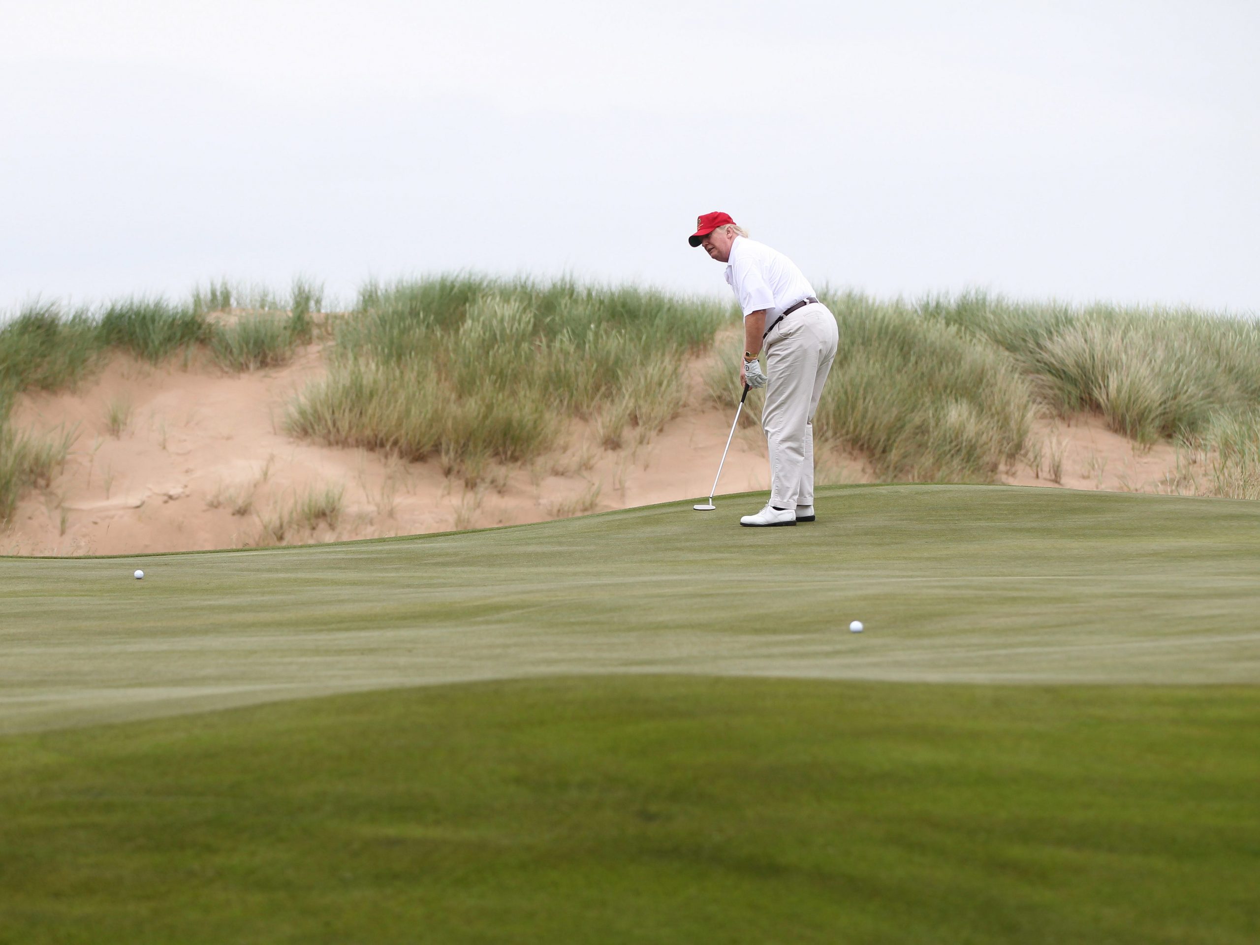 Donald Trump plays a round of golf after the opening of The Trump International Golf Links Course on July 10, 2012 in Balmedie, Scotland.