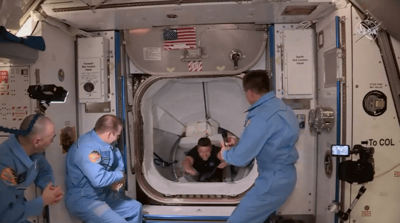 nasa astronauts bob behnken doug hurley crew dragon docking greeting international space station crew chris cassidy cosmonauts anatoly ivanishin ivan vagner iss may 31 2020