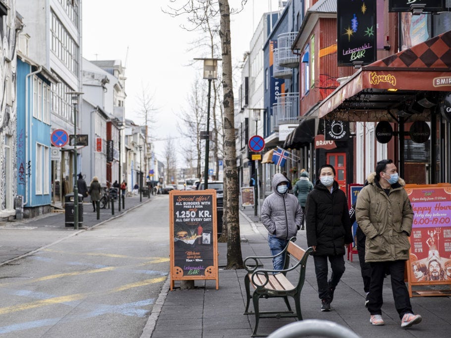 REYKJAVIK, ICELAND - APRIL 3: Tourists with masks walking down Laugavegur street in downtown Reykjavik, April 3, 2020. Ban on gatherings of 20 people or more in Iceland is ongoing during coronavirus (COVID-19) pandemic.