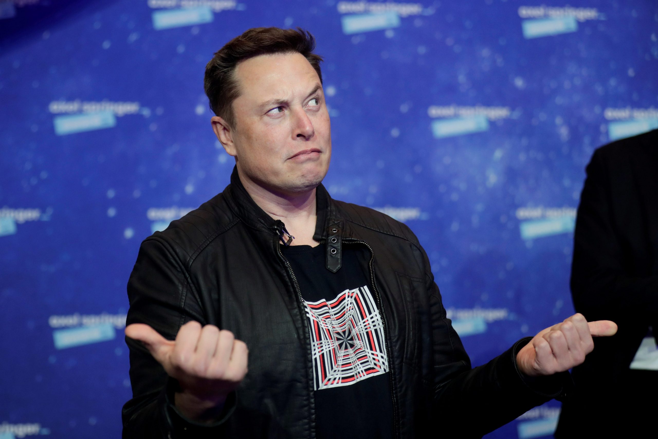 SpaceX owner and Tesla CEO Elon Musk grimaces after arriving on the red carpet for the Axel Springer award, in Berlin, Germany, December 1, 2020.