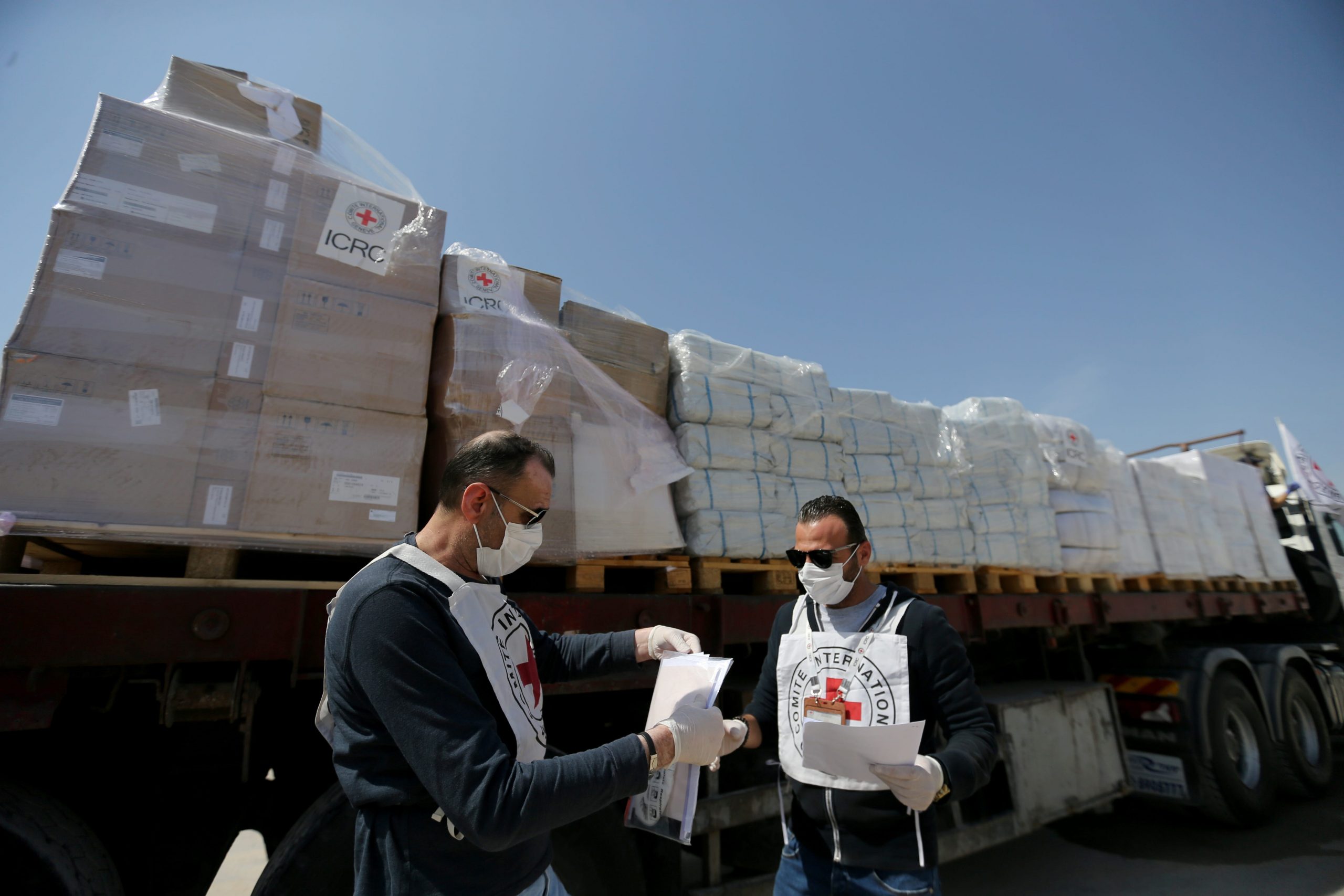Palestinian workers check medical equipment donated by the International Committee of the Red Cross (ICRC) amid concerns about the spread of the coronavirus disease (COVID-19), at Kerem Shalom crossing in the southern Gaza Strip April 21, 2020.  REUTERS/Ibraheem Abu Mustafa