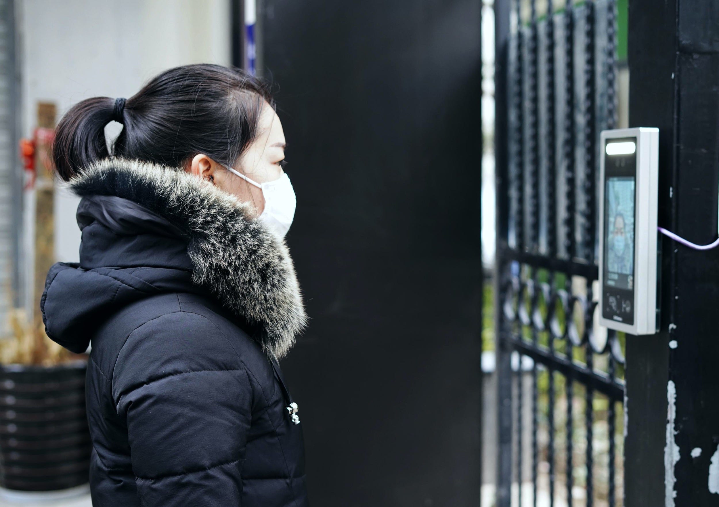 facial recognition gate  HANGZHOU, CHINA - MARCH 03: A woman wearing a face mask uses a face recognition system to enter a residence amid novel coronavirus outbreak on March 3, 2020 in Hangzhou, Zhejiang Province of China. (Photo By Cai Zixin/China News Service via Getty Images)